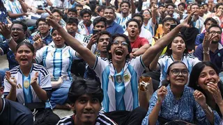 Football fans watch the 2026 FIFA World Cup match between Argentina and Jordan on a giant screen in the Dhaka University area of Dhaka, Bangladesh, on 28 June. Many of them are wearing Argentina's iconic blue and white shirt