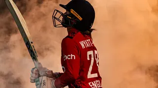 Danni Wyatt-Hodge walks through smoke before batting