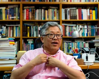 Zion Church founder Ezra Jin in a study surrounded by books