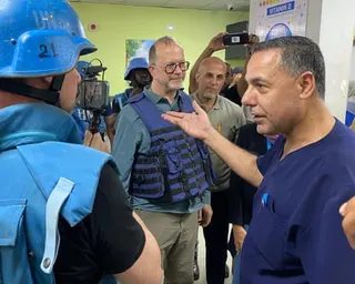 Safiya gestures while speaking to journalists and officials in the hospital