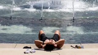 A person cools off at the World War II Memorial in Washington DC.