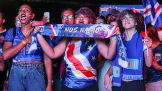Three people wearing Cape Verde clothing/merchandising during a live stream of the match