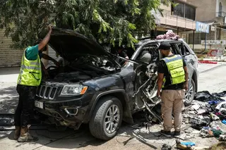First responders inspect the wreckage of a car reportedly targeted by an Israeli strike in Nabatieh, Lebanon on July 6, 2026.