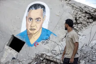 A man looks at the painted portrait of Safiya