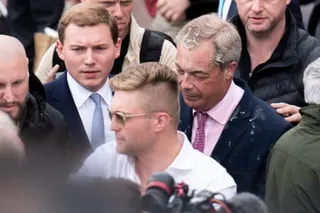 Milkshake-covered Nigel Farage standing next to Cottrell in a group of men
