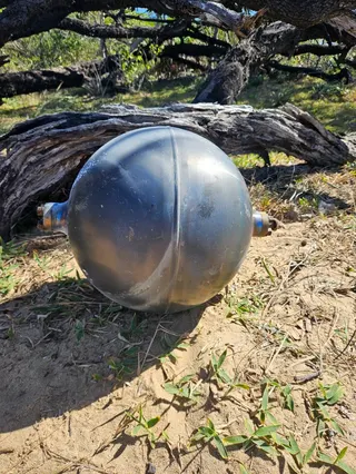 Strange black ball found in Queensland beach (QFD via X)