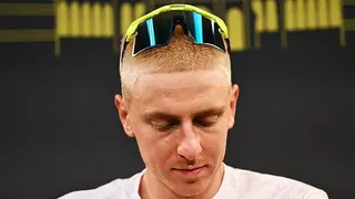 Tadej Pogacar looks downwards as he sports a close-cropped blond hairstyle