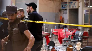 Syrian emergency services personnel work at the site a bomb blast at a cafe in central Damascus, Syria (2 July 2026)