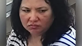 Close-up view of a woman with dark hair and a stripey t-shirt