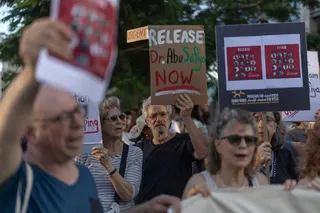 Israeli left-wing activists hold placards and chant slogans in Tel Aviv on July 6, 2026, during a rally calling for release of Palestinian prisoner, Dr Hussam Abu Safia