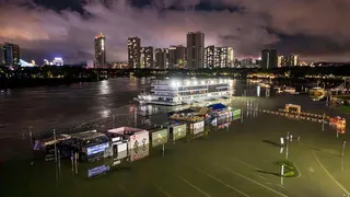 A flooded riverside walkway and shops are seen near a wharf on the Yongjiang river in Nanning, in China's southern Guangxi region