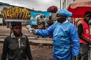 A health worker takes a woman’s temperature as part of Ebola screening efforts in Goma, Democratic Republic of Congo, in June. Photo: TNS