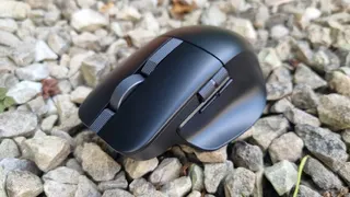 An Asus ProArt Mouse MD301 on white gravel