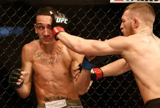Aug 17, 2013; Boston, MA, USA; Conor McGregor (black shorts) and Max Holloway (white shorts) fight during a UFC featherweight match at the TD Garden. McGregor won after three rounds by judges decision. Mandatory Credit: Winslow Townson-USA TODAY Sports