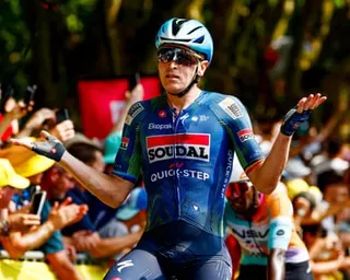 Tim Merlier shrugs his shoulders in delight after his stage victory
