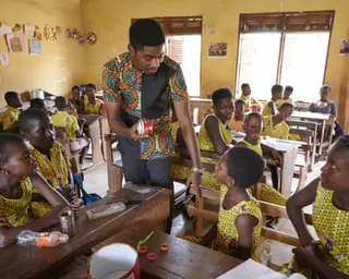 A teacher talks to children in a classroom in Ghana.