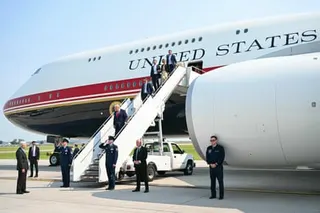 Trump walks down stairs from Air Force One.