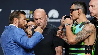 Conor McGregor and Max Holloway are held apart by Dana White