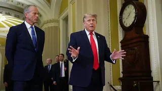 Senate Majority Leader John Thune (L) and US President Donald Trump (R) speak to reporters at the Capitol.