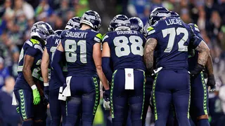 Seahawks players huddle during a game