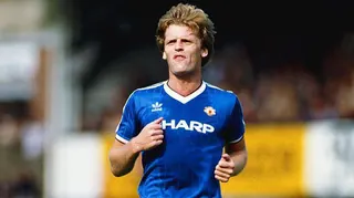 Gordon McQueen jogs while playing for Manchester United