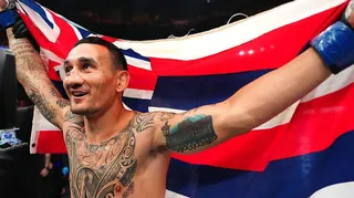 Max Holloway holds a flag