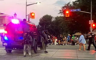 Police officers guard the site of a shooting in Toronto, Canada on Saturday. Police were searching for an active shooter after finding five people with gunshot wounds.