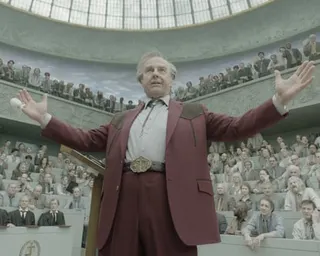 Tom Cruise (as Digger Rockwell) wearing a brown suit in Alejandro González Iñárritu's Digger.