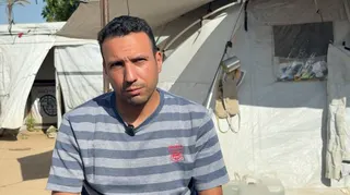 Saber Abu al-Kas sits outside a tent in Gaza
