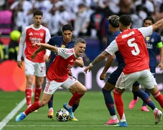 Arsenal's Leandro Trossard battles for possession against Achraf Hakimi of Paris Saint-Germain during the 2026 Champions League final