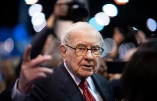 Man in suit and glasses gestures