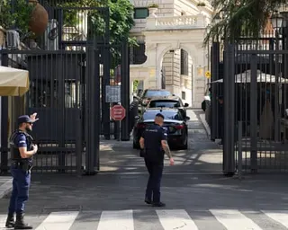 Guards at the gates of the embassy where cars have just entered