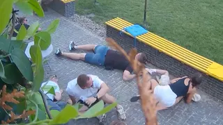 At least six people crouched on the floor as they take shelter from attack neaby