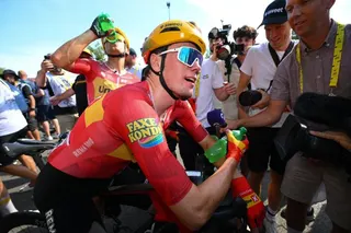 Uno-X Mobility team's Norwegian rider Soren Waerenskjold celebrates after winning the 11th stage of the 113th edition of the Tour de France cycling race
