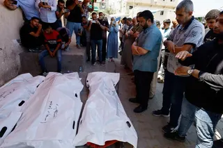Mourners pray during the funeral of Palestinian man Omar Abu Qassem, his wife Asma, and their daughter Habeeba, who were killed in an Israeli strike on Wednesday, at Al-Aqsa Martyrs hospital in Deir Al-Balah, in the central Gaza Strip, July 15, 2026. REUTERS/Mahmoud Issa
