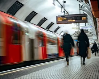 Blurred figures and tube train at an underground platform