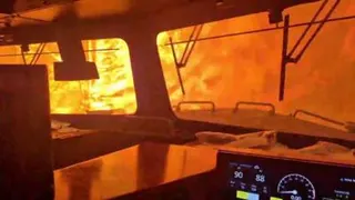 A train is surrounded by wildfire.