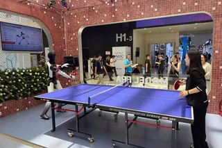 A humanoid robot plays table tennis at the World AI Conference in Shanghai.