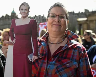 An anti-transgender rights activist holds a cut-out of writer J.K. Rowling, during a rally outside the Royal Scottish Academy in Edinburgh on April 6, 2024. Photo: Reuters