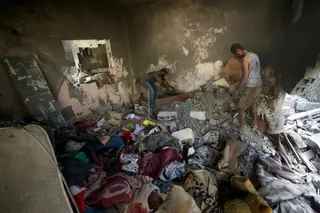 Palestinians look for their belongiongs at the site of an Israeli strike at the Bureij refugee camp in the central Gaza Strip, on July 16, 2026