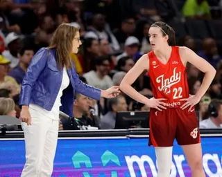 Indiana Fever head coach Stephanie White and Caitlin Clark speak during a game.