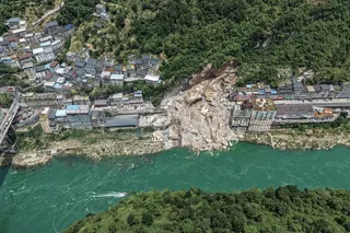 An aerial photograph shows the rain-induced landslide that has trapped citizens and destroyed buildings. Photo: Xinhua