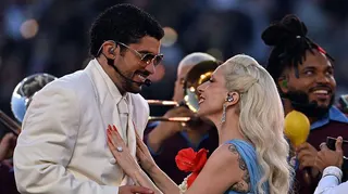 Bad Bunny and Lady Gaga smiling at each other as they perform the half-time show at Super Bowl 60