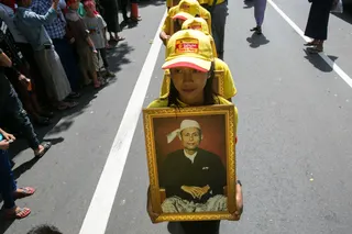Girls parade with a portrait of General Aung San during the Martyrs’ Day ceremony in Yangon on July 19, 2019. — AFP pic
