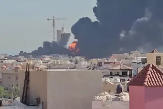 This screen grab taken from UGC video footage posted on social media on July 18, 2026, shows a plume of black smoke and flames billowing over the town of Mangaf, south of Kuwait City. Kuwait accused Iran on July 18 of targeting civilian sites and vital infrastructure in the country, after reporting attacks on an oil facility and a power and water plant. (Photo by various sources / AFP) / RESTRICTED TO EDITORIAL USE - MANDATORY CREDIT AFP -  SOURCE: UGC / UNKNOWN - DISTRIBUTED AS A SERVICE TO CLI