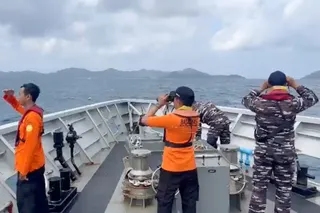 Rescuers scan the horizon on July 16, 2026 as they search for victims after a passenger boat sank in the waters near Selayar Island in South Sulawesi, Indonesia