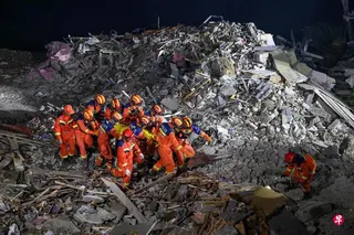 救援人员星期五（7月17日）在重庆市彭水县山体滑坡现场抬走一名遇难者遗体。 （法新社）