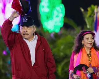 Nicaragua's President Daniel Ortega waving next to wife and co-President Rosario Murillo