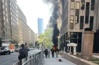 flames and smoke rise outside a building