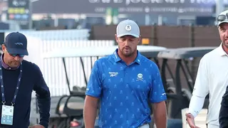 Bryson DeChambeau speaks with a rules official at Royal Birkdale.